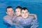 A Happy joyful family swims in the pool, water