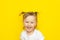 Happy Joyful laughter of little girl in white shirt on yellow background.