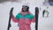 Happy joyful woman in ski goggles and suit dancing in slowmo at winter resort. Middle shot of cheerful relaxed Caucasian