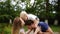 Happy joyful young family father, mother and little son having fun outdoors, playing together in summer park