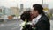 happy just married pair is kissing on city street in wedding day