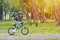 Happy kid boy of 5 years having fun in spring park with a bicycle on beautiful fall day. Active child wearing bike helmet