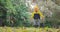 Happy kid, cute boy playing outdoor with colorful fallen leaves in autumn park