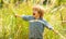 Happy kid. Cute child on nature grass background. Happy scream, delight. Childrens emotions on a beautiful face