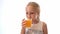 Happy kid drinking fruit juice .