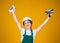 happy kid engineer with plastering tool spatula in hard hat, inspector