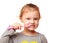 Happy kid girl brushing white teeth
