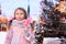 happy kid girl with christmas candy. Winter holiday portrait in the evening Moscow city