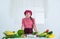 happy kid girl in cook hat and apron in kitchen, dieting