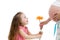 Happy kid girl gives flower to pregnant mother