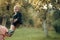 Happy kid having fun. Cute toddler smile in suit, shirts, sneakers under tree, fashion