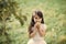 Happy kid having fun. Little girl eat apple on natural background, vitamin