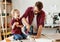 Happy kid helping father in carpentry studio