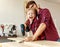 Happy kid helping father in carpentry studio