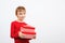 Happy kid holding gift boxes surprise. Happy little boy with presents isolated over white background