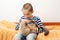 Happy kid hugging his cat. Boy relaxing on the bed with pet. Childhood, true friendship and home pet