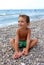 Happy kid on pebbly beach
