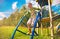 Happy kid playing on playing ground, blue sky, summer