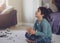 Happy kid sitting on floor clapping hands while watching cartoon onTV in living room, Cheerful child boy wearing pyjama sitting on