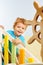 Happy kid sitting on the playground stairs