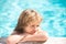 Happy kid in swimming pool. Children in tropical resort. Family beach vacation and summer activity.