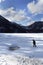 Happy kid walk in frozen beautiful lake