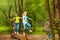 Happy kids balancing standing on the log in forest