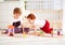 Happy kids, brothers playing together with wooden toy railway in nursery room