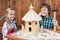 Happy kids building a bird house