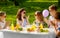 Happy kids with cake on birthday party in summer