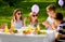 Happy kids with cake on birthday party in summer