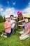 Happy kids in colorful helmets repair bike