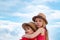Happy Kids embrace on blue sky background. Valentines day. Childhood on countryside. Cute little children enjoying at