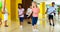 Happy kids and female teacher dancing together in studio at elementary school