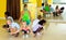 Happy kids and female teacher dancing together in studio at elementary school