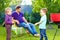 Happy kids fighting with kitchen items on picnic