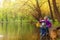 Happy kids fishing together near beautiful pond