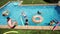 Happy kids have fun swim pool with inflatable toys