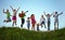 Happy kids jumping on summer field