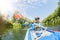 Happy kids kayaking on the river on a sunny day during summer vacation