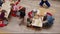 Happy kids paint cardboard animal in room view from above