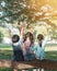 Happy kids in the park having fun sitting under tree shade playing together enjoying good memory and moment of student lifestyle