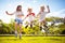 Happy kids play outdoor. Children skipping rope