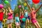 Happy kids playing and catching colorful balloons