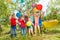 Happy kids playing colorful balloons outside