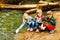 Happy kids playing with paper boats at river bank