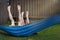 Happy kids relaxing in a hammock outdoor. children`s feet barefoot. Holidays vacation