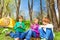 Happy kids resting together sit near yellow tent