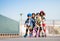 Happy kids rollerblading in a row outdoors