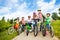 Happy kids in row wear colorful bike helmets